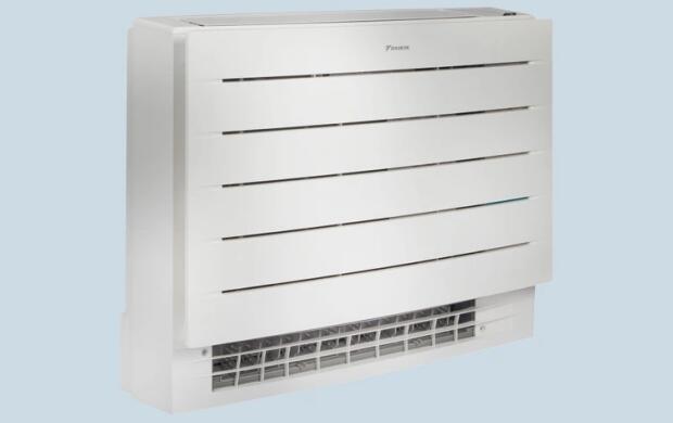 Een witte, wandmontage airconditioner tegen een lichtblauwe achtergrond.