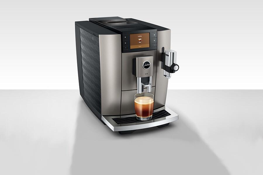 Een moderne espressomachine met een kopje koffie eronder geplaatst.